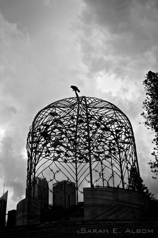 A black and white photo of a bird sitting atop a sculpture in the Sydney Botanical Gardens in Australia. Copyright Sarah E. Albom 2015; for more photos of Australia, visit the blog