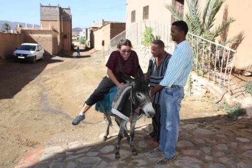 Learning to ride a donkey, Morocco riding a donkey