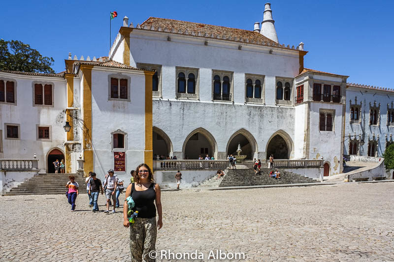 6 Enchanting Castles of Sintra: Explore the Palaces 12 Teen standing outside the National Palace of Sintra in Portugal