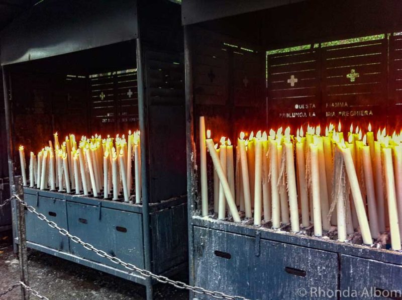 Pilgrims and other visitors can light candles at the grotto for dipping into the Lourdes healing water France