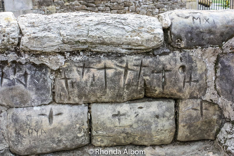 Northern Spain Road Trip: From the Atlantic to the Mediterranean 18 Crosses carved into the stones on a wall near the Church of the Colegiata in Santillana Del Mar, an overnight stop on our northern Spain road trip