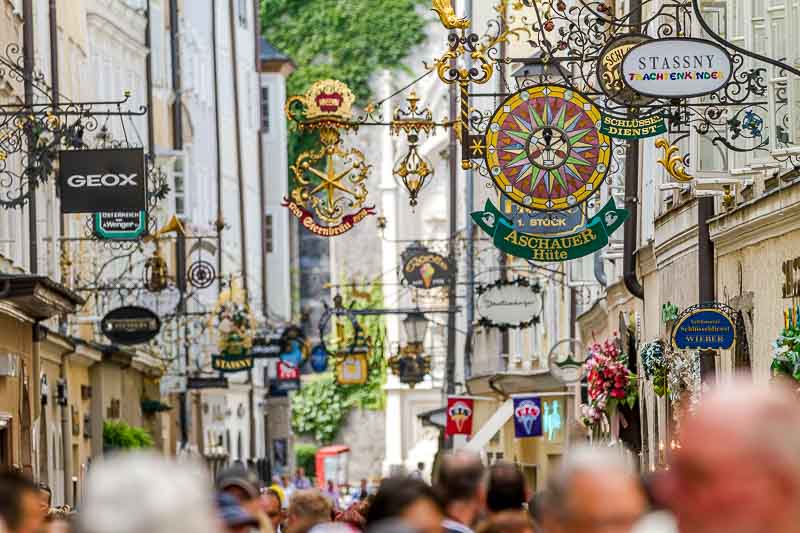 People walking along Getreidegasse, the famous historical shopping and a must see with one day in in Salzburg Austria