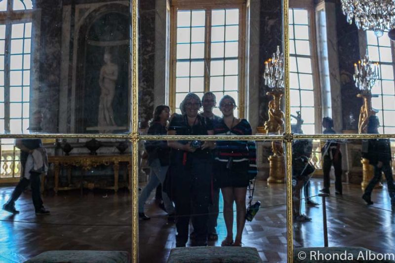 Family photo in the Great Hall of Mirrors on our Paris day trip to Versailles