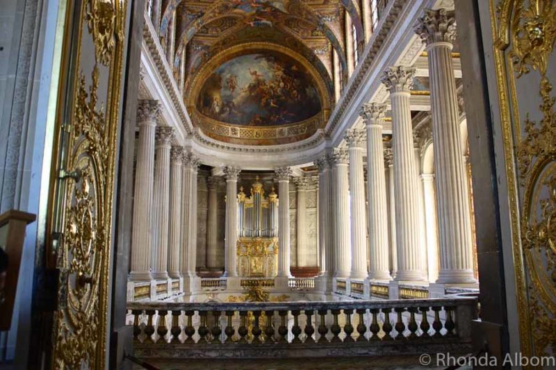 View of columns and high domed ceilings in the Palace of Versailles