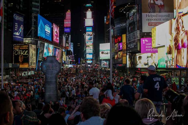 Crowded Times Square at night, one of the New York City highlights