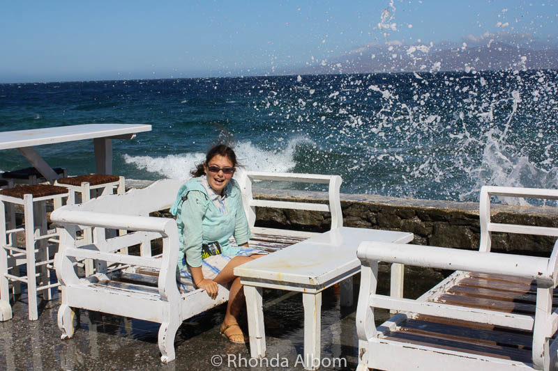 Windmills of Mykonos, Whitewash Buildings: Why We Love this Cruise Port 13 Water splashing over a seawall on a Greek island
