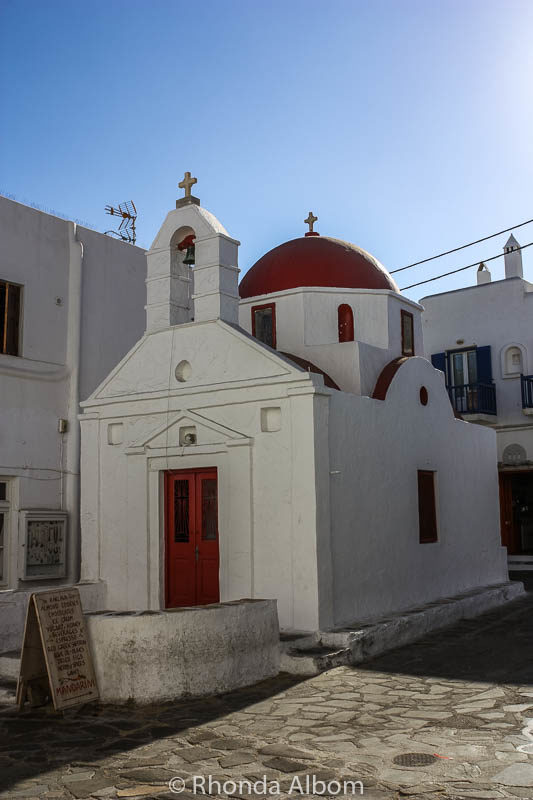 Windmills of Mykonos, Whitewash Buildings: Why We Love this Cruise Port 9 A classic red roofed chapel on a Greek island