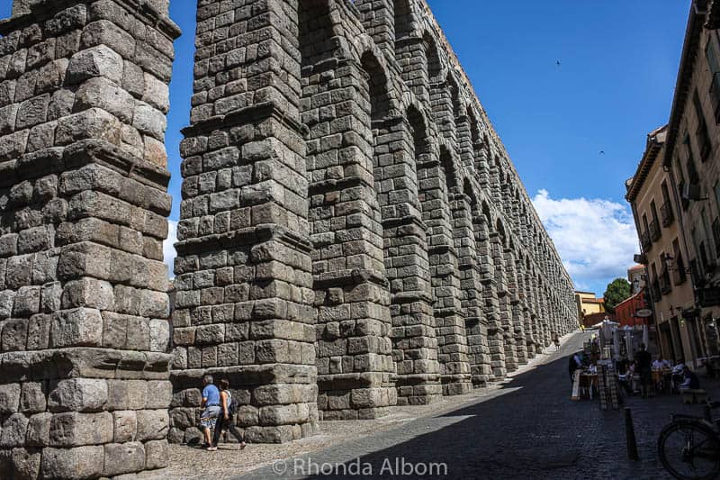 The ancient aqueduct seen from ground level is one of the most impressive things to do in Segovia Spain