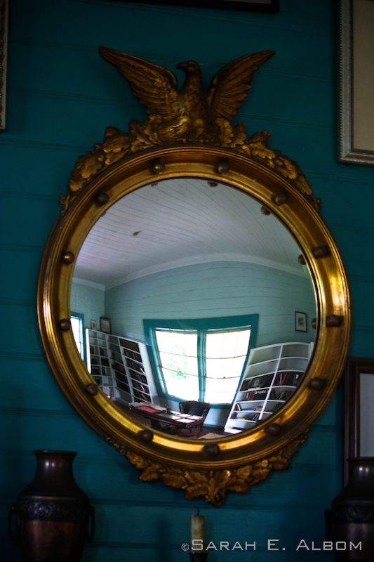 Reflection from a mirror of Robert Stevenson's Library in the Robert Louis Stevenson Museum in Samoa. Photo copyright ©Sarah Albom 2014