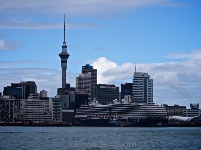 Getting Around New Zealand: Local Intel on Travel & Booking 10 Auckland skyline seen from the ferry into the city. The HAL Oosterdam is in port.