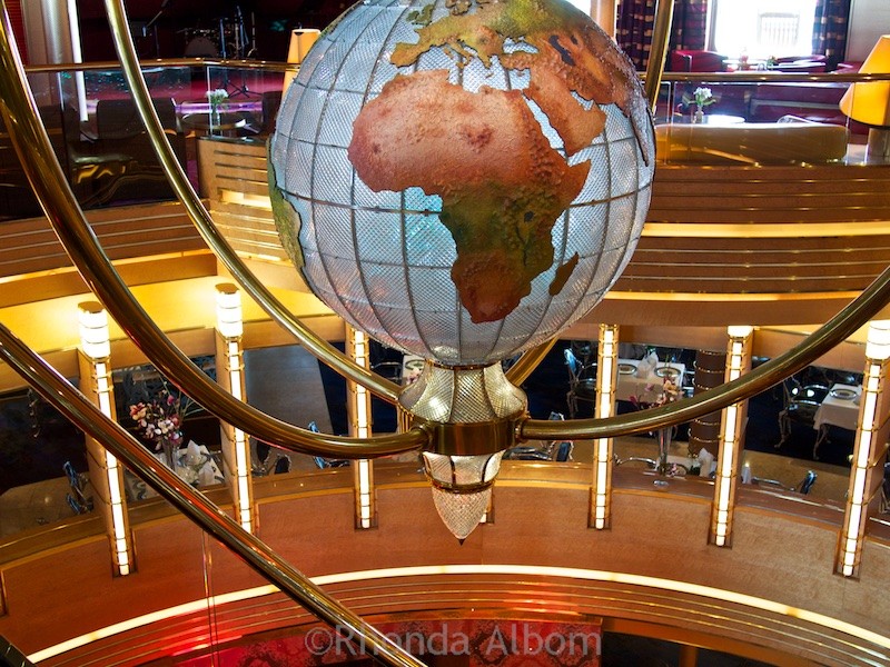 Repositioning Cruises: Are they right for you? 11 This globe sits over the atrium of the Holland America Oosterdam cruise ship.