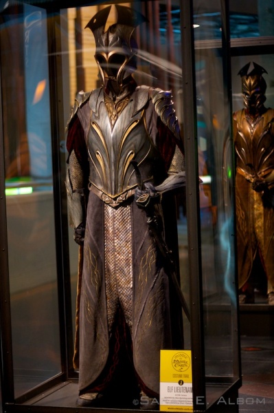 LoTR Elf Lieutenant costume in the Te Papa museum in Wellington, New Zealand. Behind it can be seen another costume for an elf soldier. The detail and metal-work was impressive, but was was more amazing was how many they must have made of both of these in order to stock an army (or at least the fifty or hundred people acting out all the scenes). For more pictures about the Hobbit movie costumes trail check out the original article at Albom Adventures