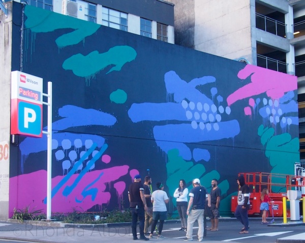 Auckland's K-Road is Street Art and Alternative Fun 3 Artist Askew One in front of his completed street art in Auckland New Zealand