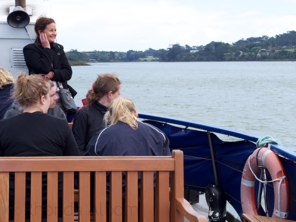 People enjoying a Riverhead cruse on the Upper Harbour Estuary in Auckland, New Zealand