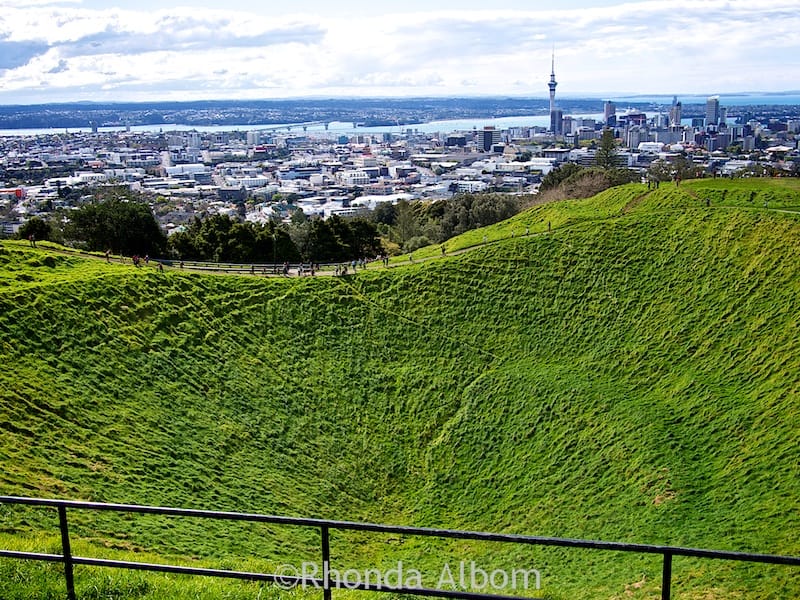 The Auckland city skyline seen while looking over the 50 metre crater of the extinct Mount Eden Volcano, Auckland New Zealand.