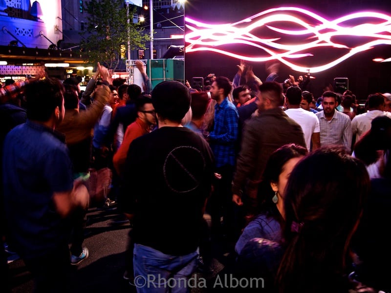 Changing light patterns filled the screen complimenting the DJ's music while people danced at the 2015 Auckland Diwali Festival in New Zealand