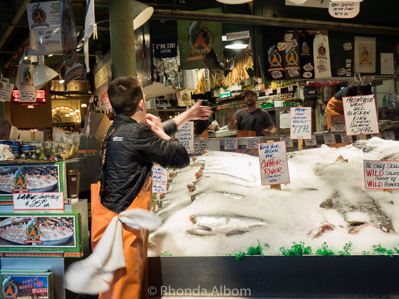 A fishmonger catching fish in Seattle Washington