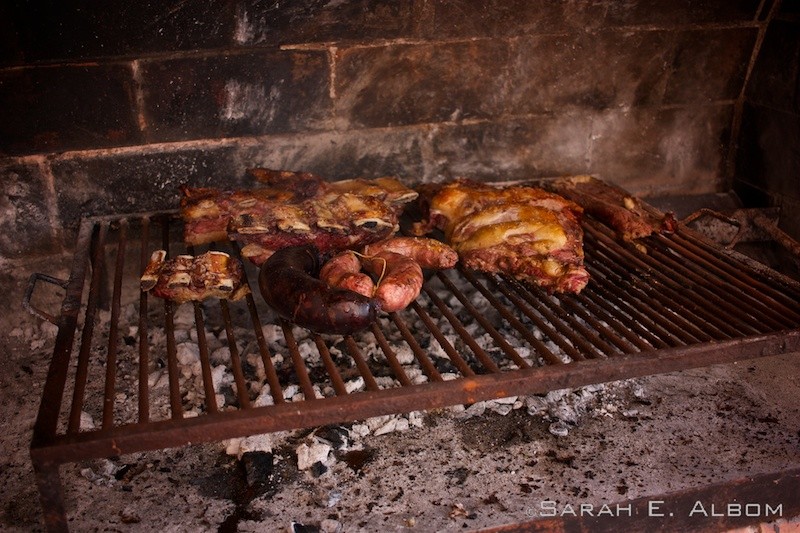 Asado is an Argentinian barbecue made with a variety of meat from different animals on a family grill. 