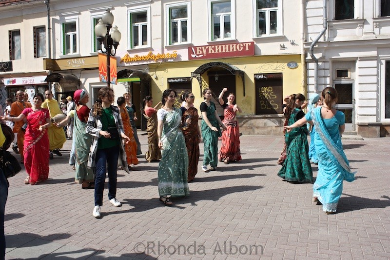 Hare Krishnas dancing and parading down Arbat Street in Moscow Russia
