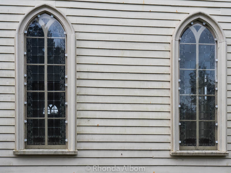Things to Do in Russell: Dark History of NZ's First Capital 7 Musket holes in the side of Christ Church, New Zealand's Oldest Church located in Russell