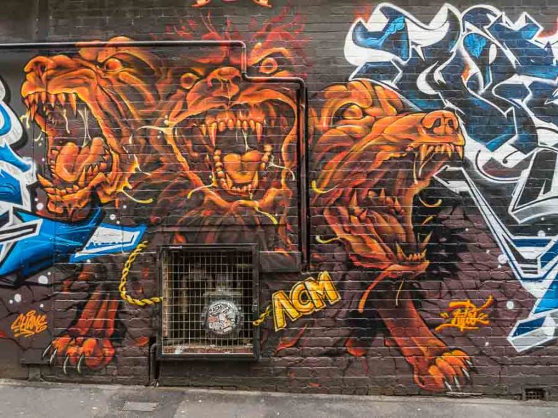 Explore Melbourne Street Art and Graffiti Laneways 12 Three headed dog street art on Drewery Lane from 2016 that is now almost completely covered by graffiti in Melbourne Australia