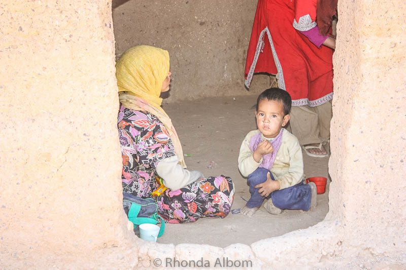 A mother and child inside their building.