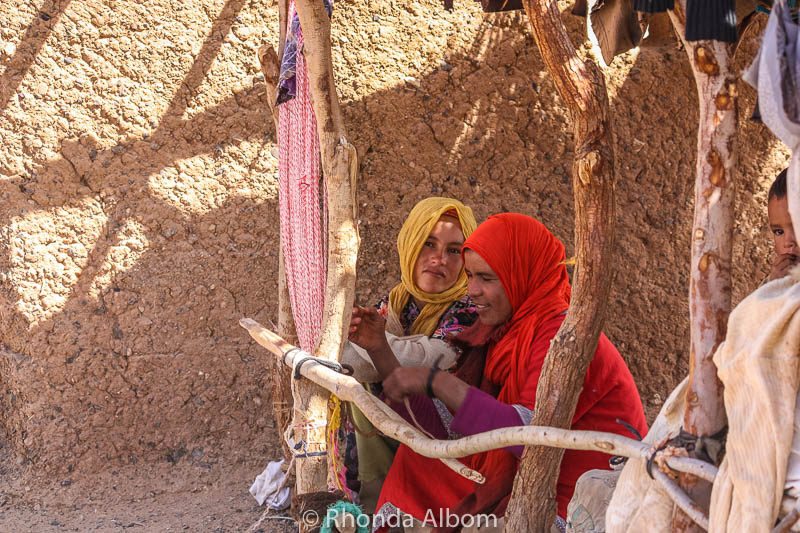 Two women weaving a rug in Morocco