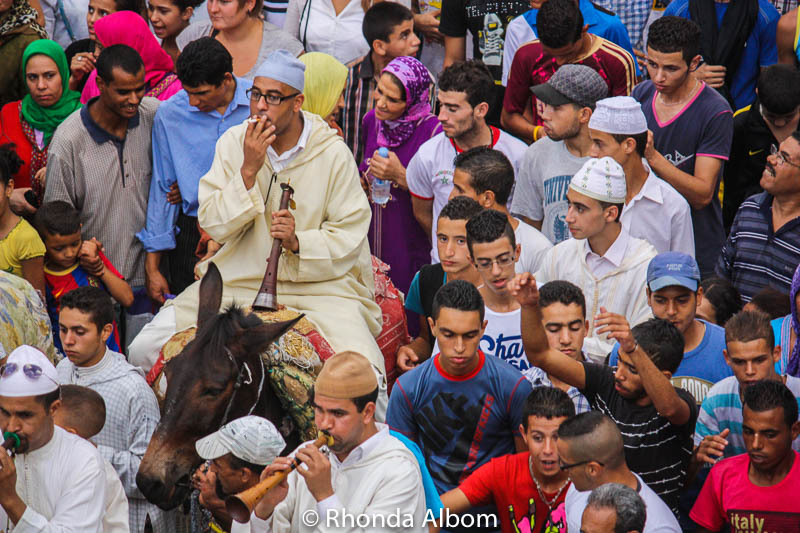 Musician pauses for a smoke during the Moussem of Moulay Idriss II in Fes Morocco