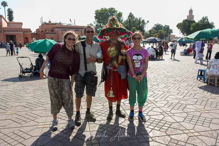 10 of the Best Things to Do in Marrakesh Morocco 4 family with a water carrier in Jemaa el Fna