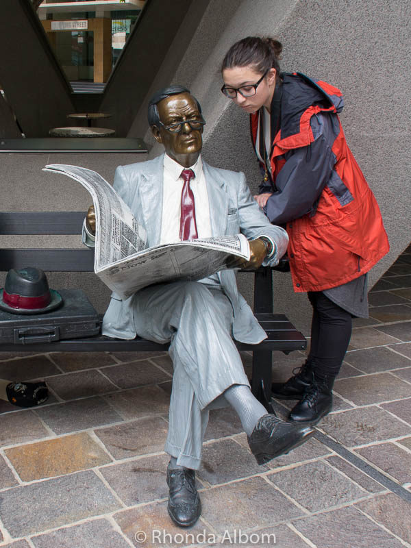Man reading a newspaper sculpture in Sydney Australia