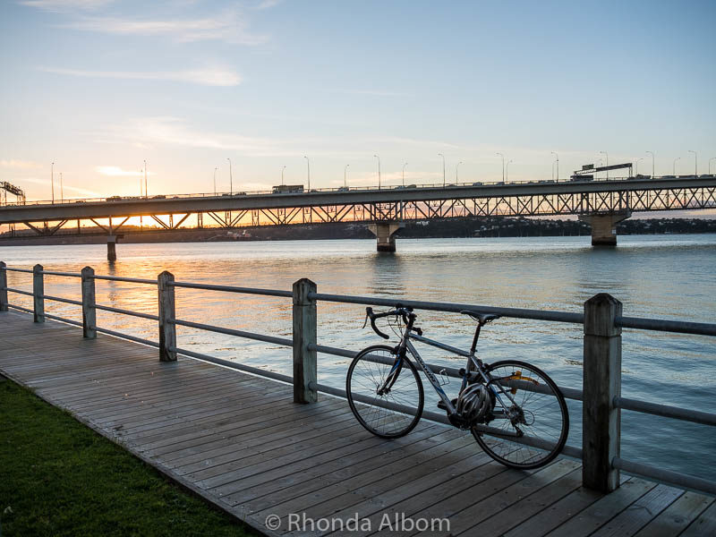 A bicycle leans against boardwalk fence in Auckland New Zealand