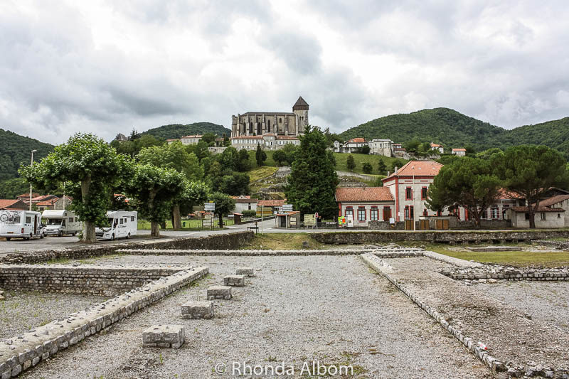 Saint Bertrand de Comminges towering over the archeological site of the Roman Ruins of Lugdunum, France