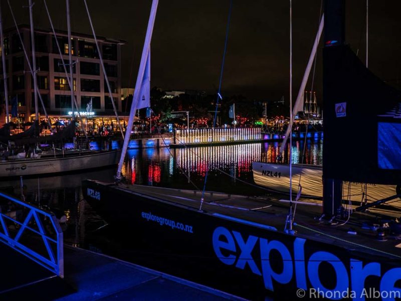 Former New Zealand Americas Cup boats seen during the light festival in Auckland at night.