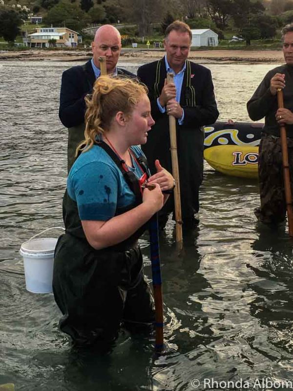 Our guide at Dive Tatapouri explaining how to feed the stingrays to our group including Sir John Key and Christopher Luxon