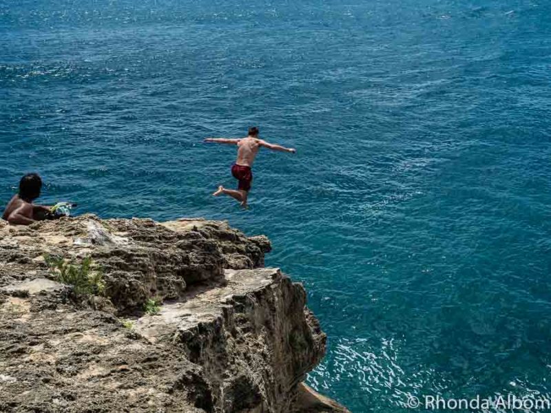 Leaping off the cliff at Shipwreck Point on Kauai Hawaii