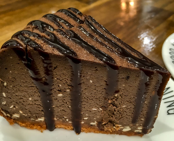 20 Unique Restaurants in Auckland New Zealand to Try in 2023 15 Chocolate caramel cheesecake with purple icing from Mellow Coffee and Desserts in New Zealand