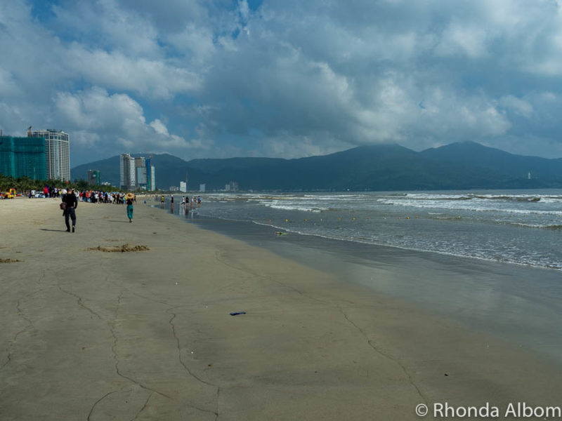 Looking down the long stretch of white sand and gentle waves at My Khe beach, once called China Beach Da Nang.