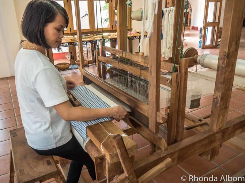 9 Things to Do in Hoi An Vietnam: A Day Trip from Da Nang 17 Women demonstrates the silk weaving machines at Yaly Couture one of the Hoi An attractions