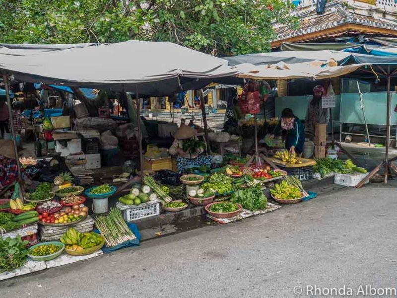 Fruit and vegetables are some of the best food in Hoi An sold at stalls along the road just outside the central market]