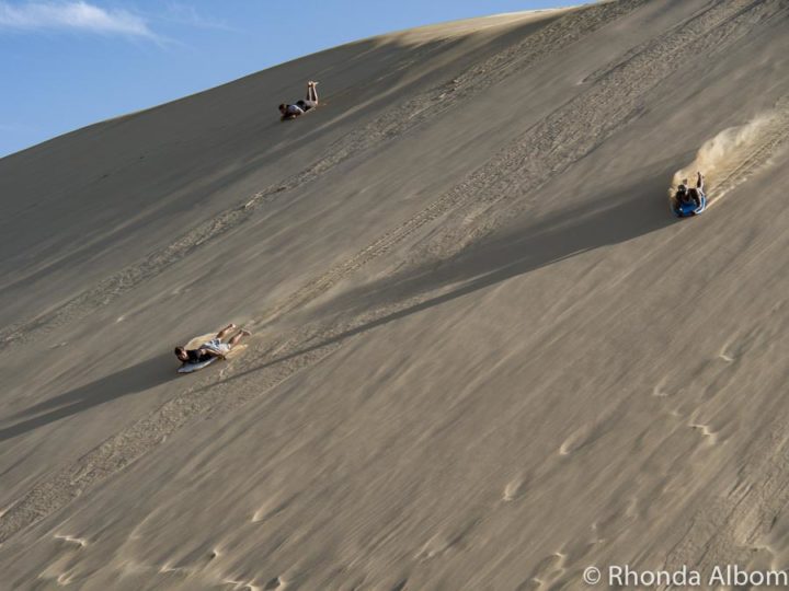 Sandboarding at Te Paki Sand Dunes, New Zealand