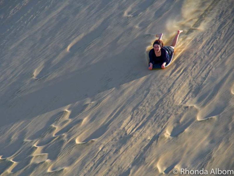 Sandboarding at Te Paki Sand Dunes, New Zealand 5 A girl sandboarding New Zealand style - full speed down the Giant Te Paki Sand Dunes in Northland, New Zealand