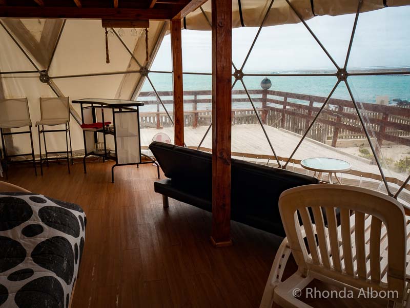 Inside a glamping tent looking out at the ocean in one of many hotel alternatives in Chile