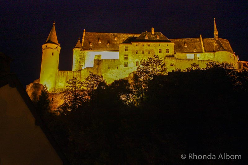 Hotel Alternatives: Get Local and Enjoy Culture without Sacrificing Comfort 7 Golden light on a castle on a hill against the black night sky and seen from one of the many hotel alternatives in Luxembourg