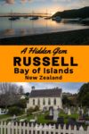Boats at anchor in the Bay of Islands as seen from the shore and the Christ church and graveyard in Russell Bay of Islands New Zealand