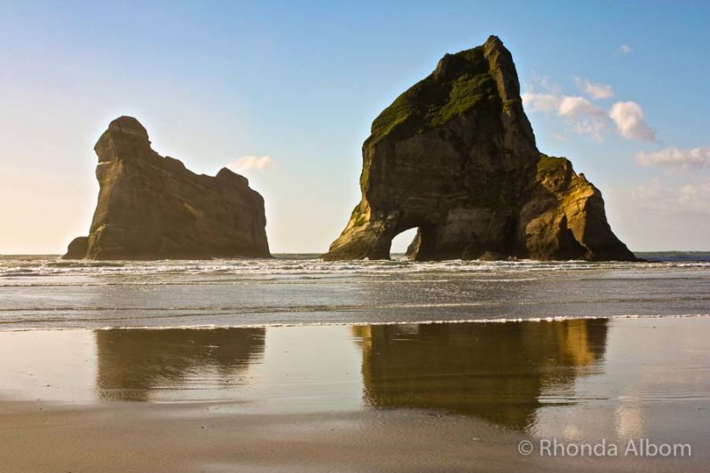 A giant archway or hole called Archway Island and seen from Wharariki Beach at the top of the South Island, New Zealand