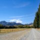 A dirt road leading to the mountain as part of several New Zealand road trips