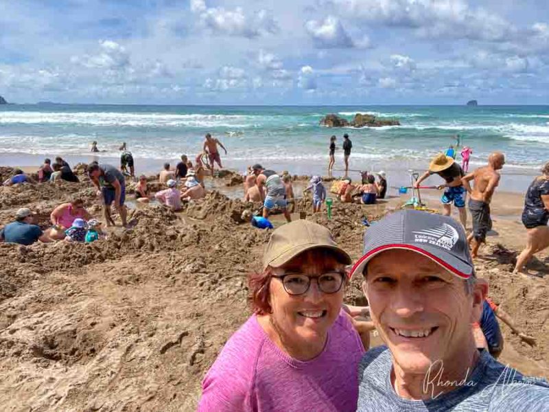 Day Tours from Auckland: 5 Top Destination Options Made Easy 8 Us at Hot Water Beach, one of the cool places you can visit on several of the tours from Auckland New Zealand.