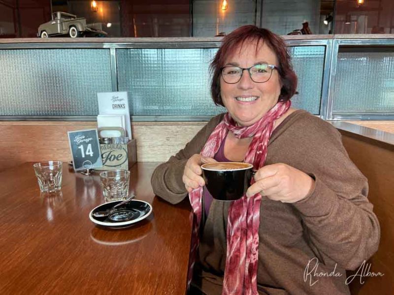 Gluten-Free Hibiscus Coast Restaurants: Orewa to Gulf Harbour 9 Rhonda Albom drinking coffee at Joe's Garage in Silverdale