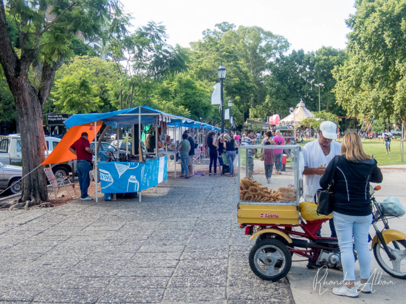 Things to do in Rosario Argentina - Home to More than Just the Flag 16 Churros vendor with the market behind, near the waterfront in Rosario Argentina
