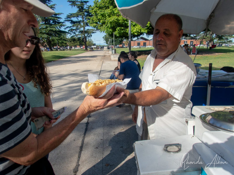 Jeff getting a Super Pancho hotdog in the park in Argentina